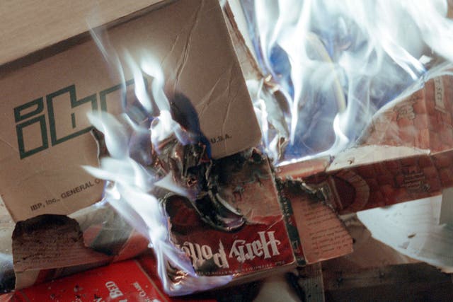 A copy of Harry Potter burns during a protest in New Mexico – the pastor called it a ‘masterpiece of satanic deception’