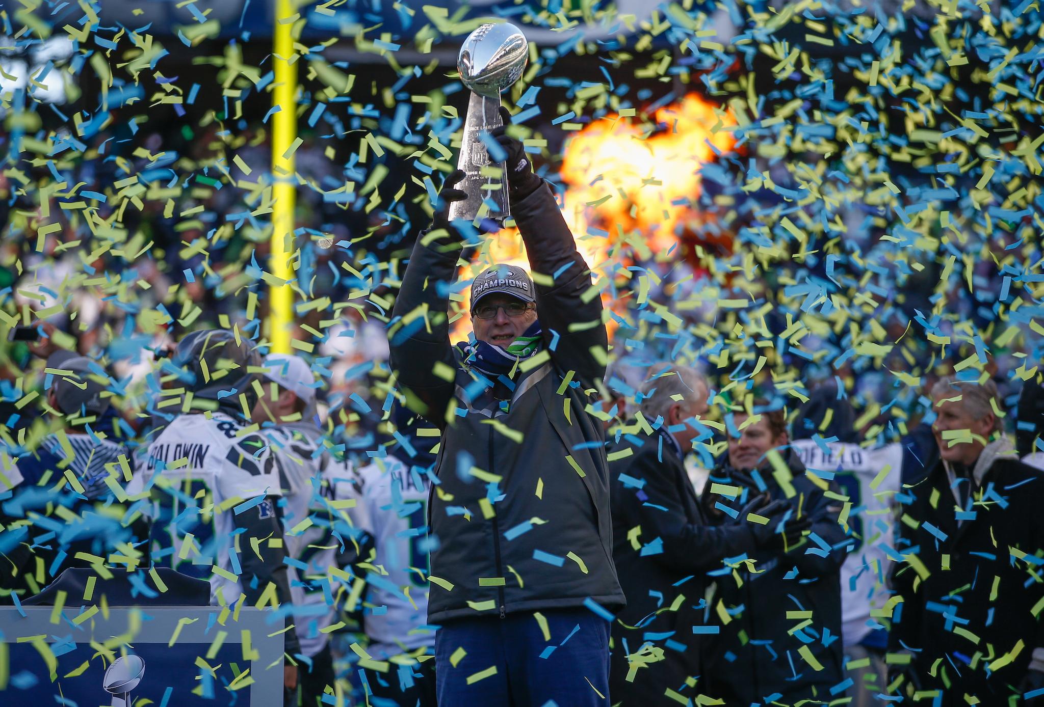 Team Owner Paul Allen of the Seattle Seahawks holds the Lombardi Trophy during ceremonies following the Super Bowl XLVIII Victory Parade at CenturyLink Field on February 5, 2014