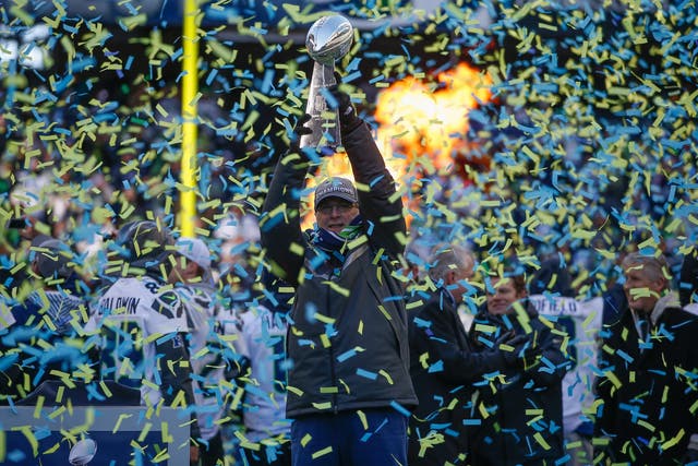 Team Owner Paul Allen of the Seattle Seahawks holds the Lombardi Trophy during ceremonies following the Super Bowl XLVIII Victory Parade at CenturyLink Field on February 5, 2014