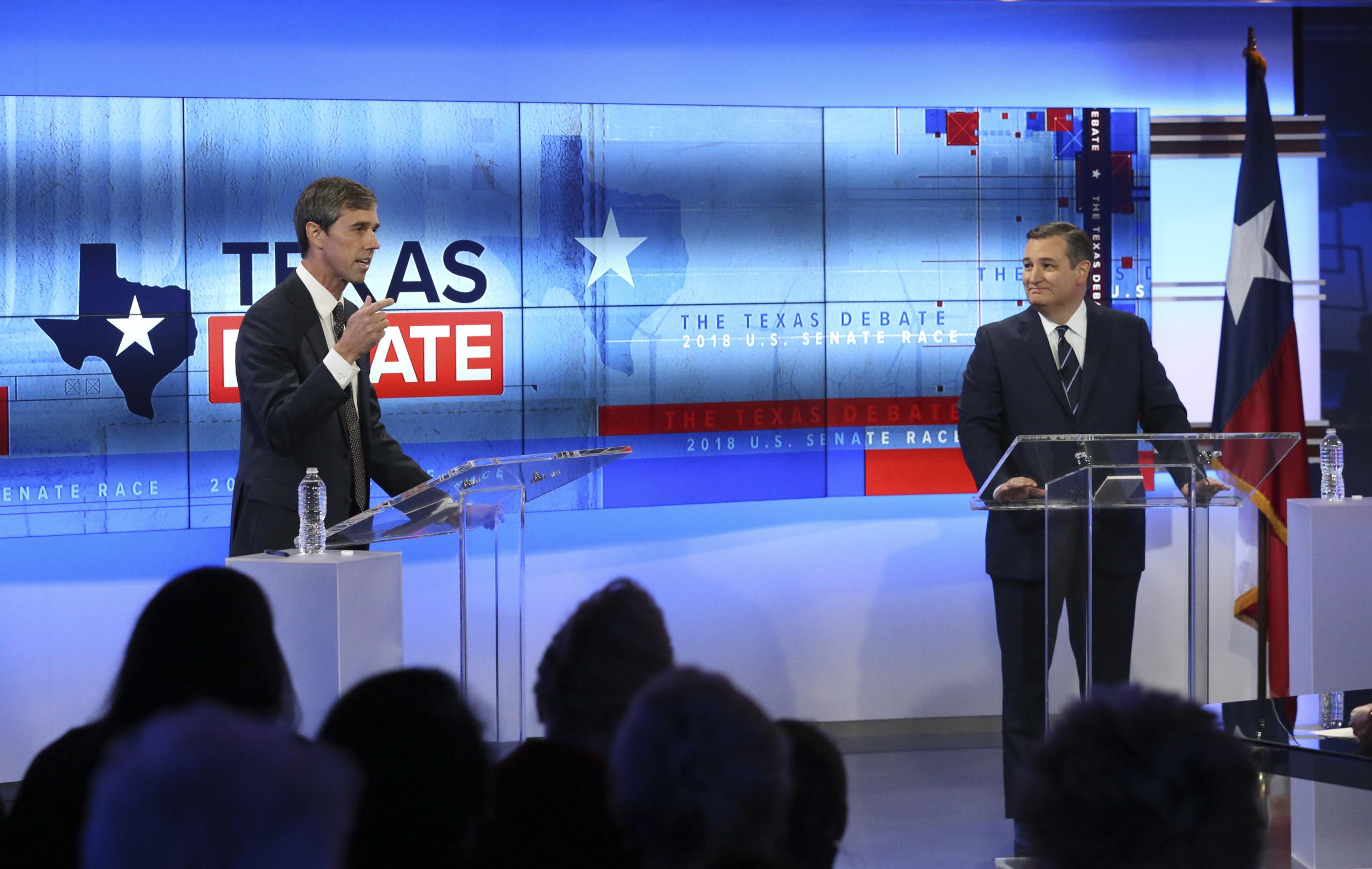 Ted Cruz listens to Beto O'Rourke as he responds to a question during the final US Senate debate in San Antonio, Texas 16 October 2018.