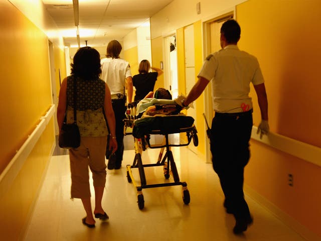 Paramedics and parents walk in an injured child into the emergency room