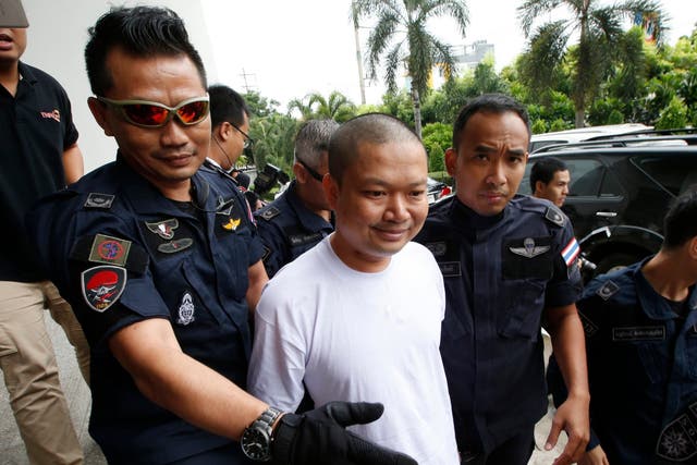 Ex-monk Wirapol Sukphol is escorted by the Department of Special Investigation officials to the prosecutor's office in Bangkok