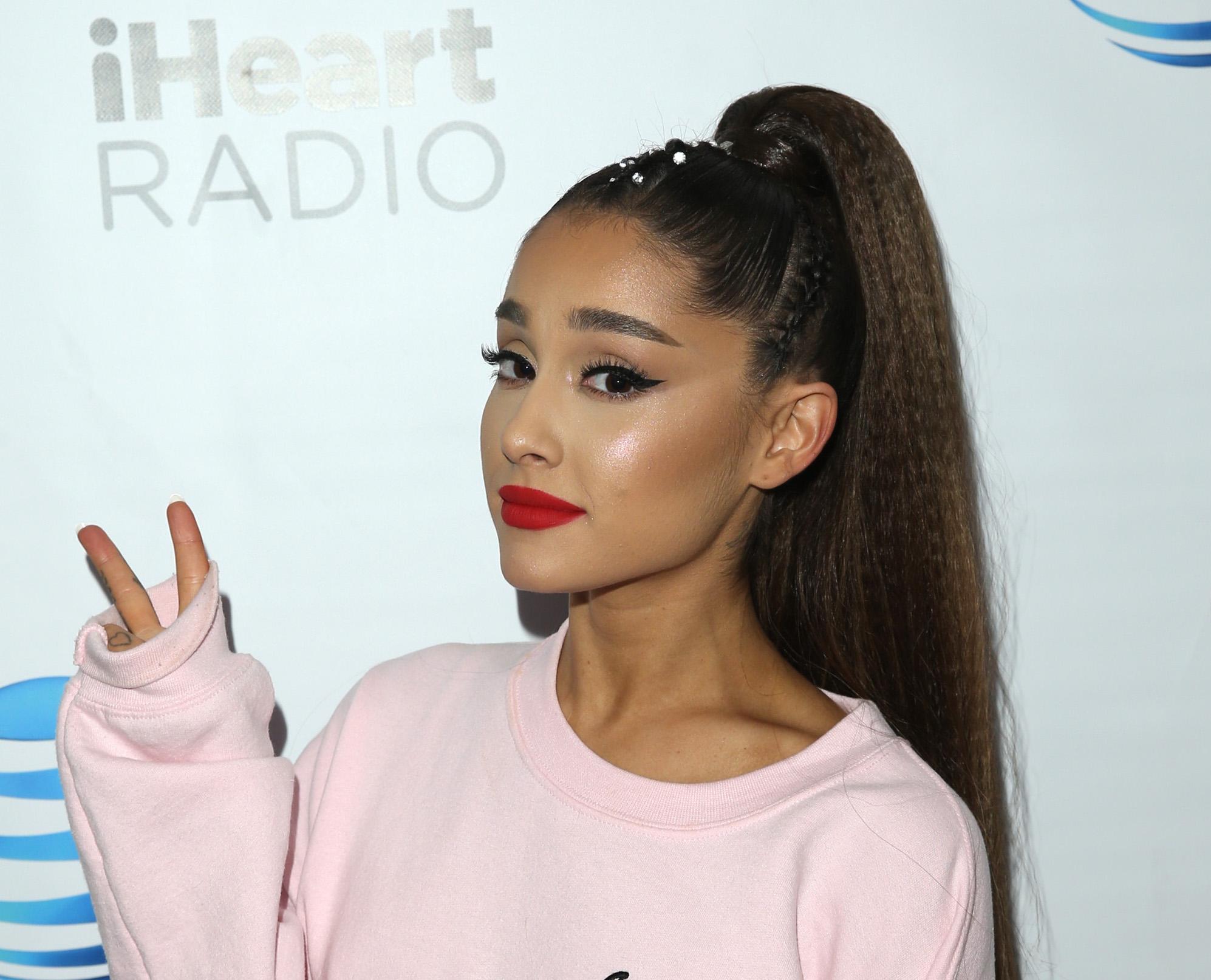 Ariana Grande cuts a stylish figure as she touches down in Japan