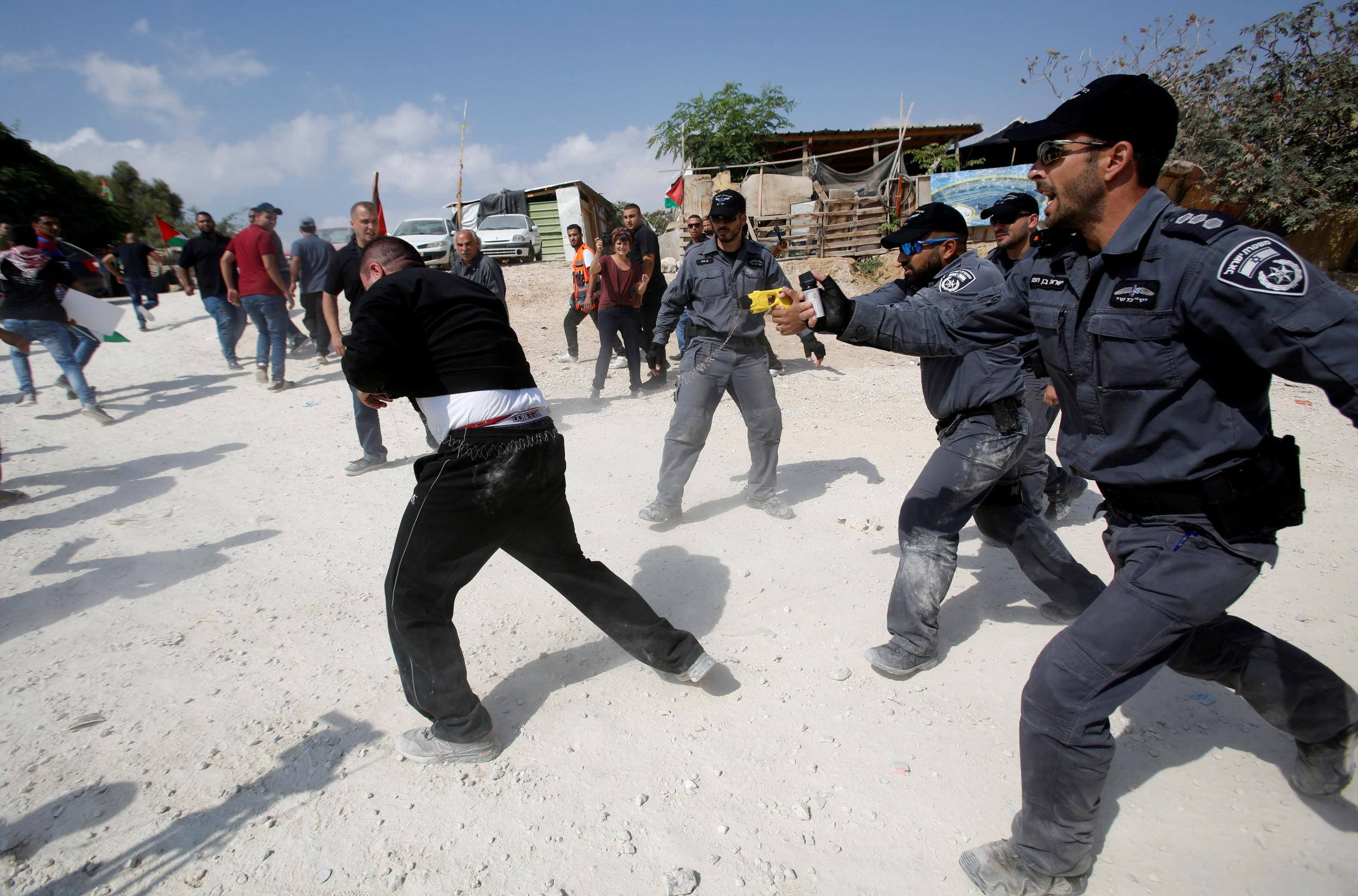 Israeli policemen disperse activists in the Palestinian Bedouin village of Khan al-Ahmar that Israel plans to demolish, in the occupied West Bank October 17, 2018.