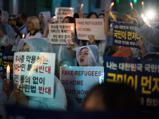 Anti-immigration activists attend a protest against a group of asylum-seekers from Yemen, in Seoul on June 30, 2018
