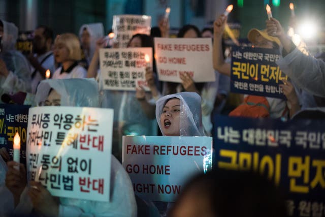 Anti-immigration activists attend a protest against a group of asylum-seekers from Yemen, in Seoul on June 30, 2018