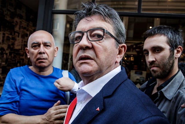 Jean-Luc Melenchon reacts after a police search at his party headquarters in Paris