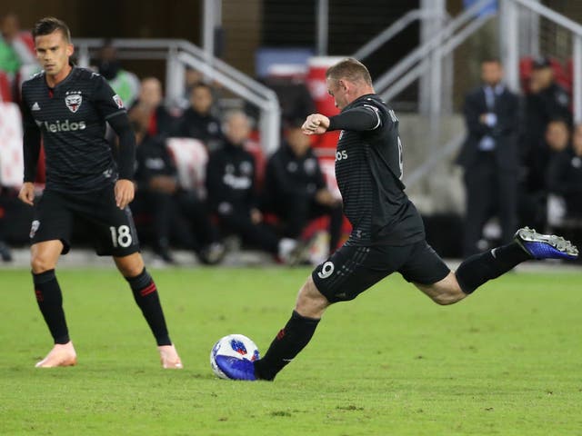 D.C. United forward Wayne Rooney scores a goal