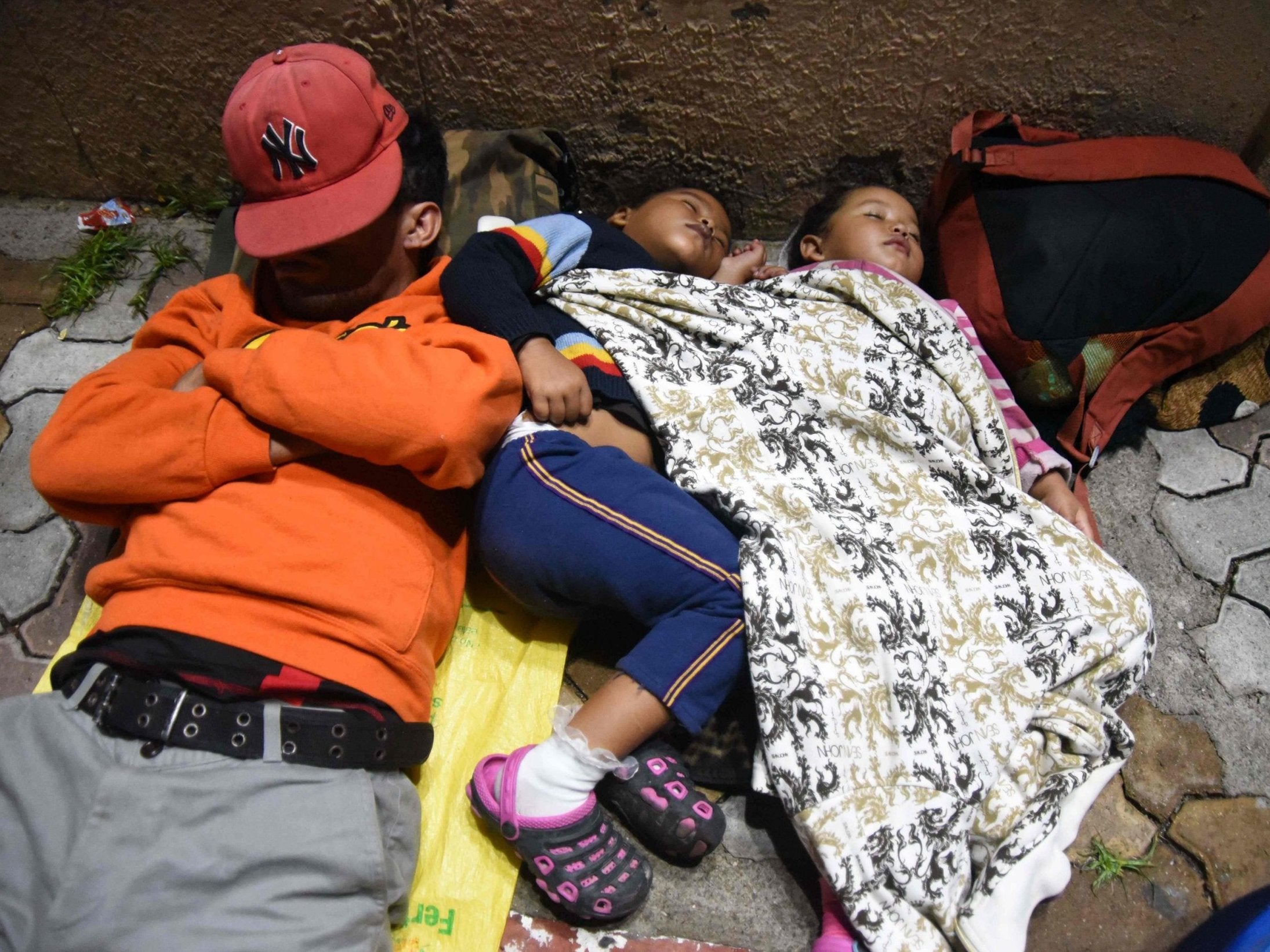 Honduran migrants sleep in Chiquimula, Guatemala, on 17 October
