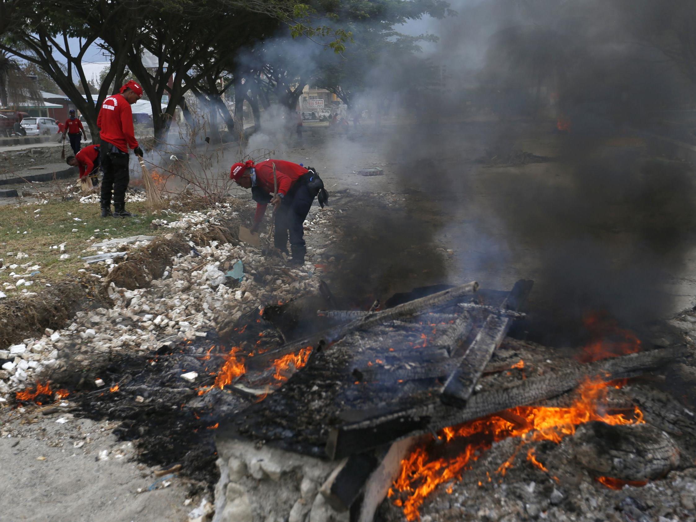 Rescuers burn debris