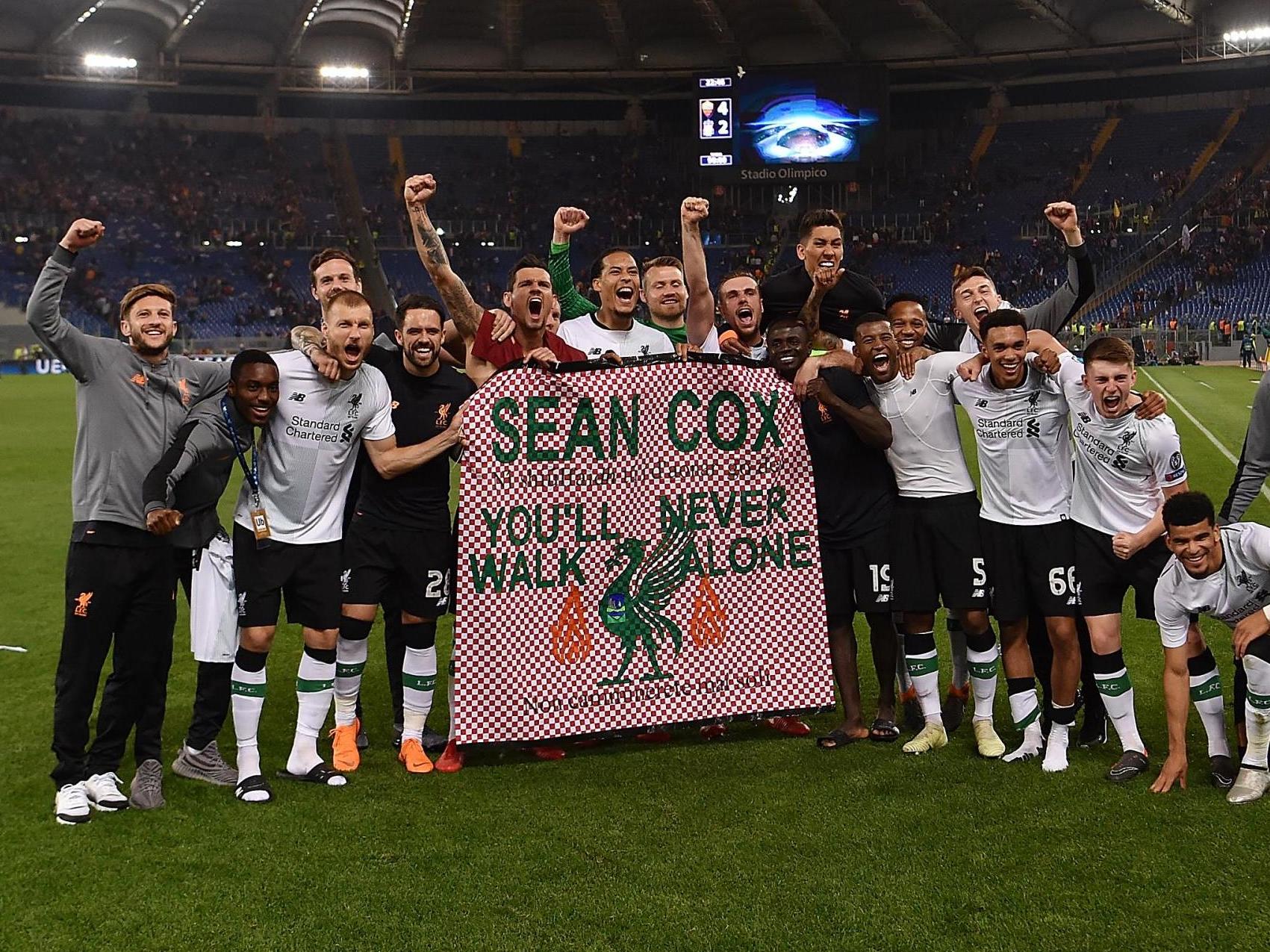 Liverpool players hold a message of support for Sean Cox after the second leg