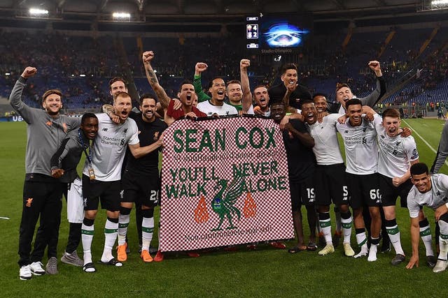 Liverpool players hold a message of support for Sean Cox after the second leg