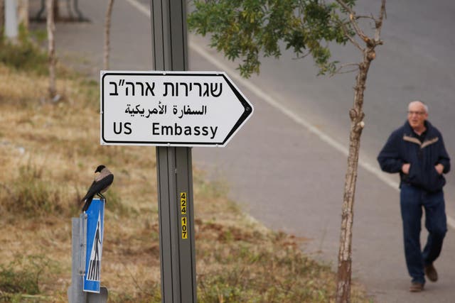 A man walks next to a road sign directing to the US embassy, in the area of the U.S. consulate in Jerusalem, May 7, 2018