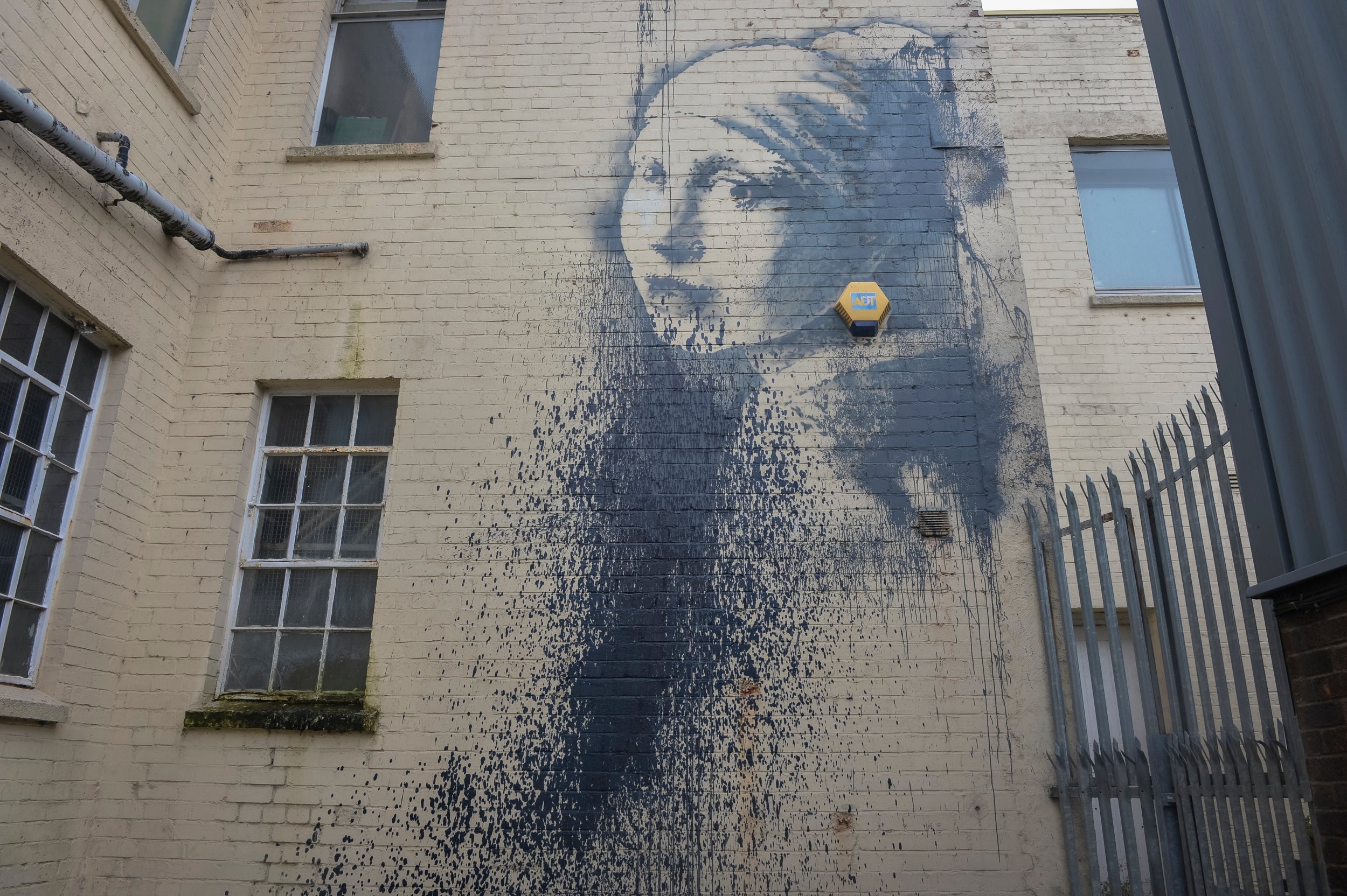 An outdoor security alarm replaces Vermeer’s pearl earring