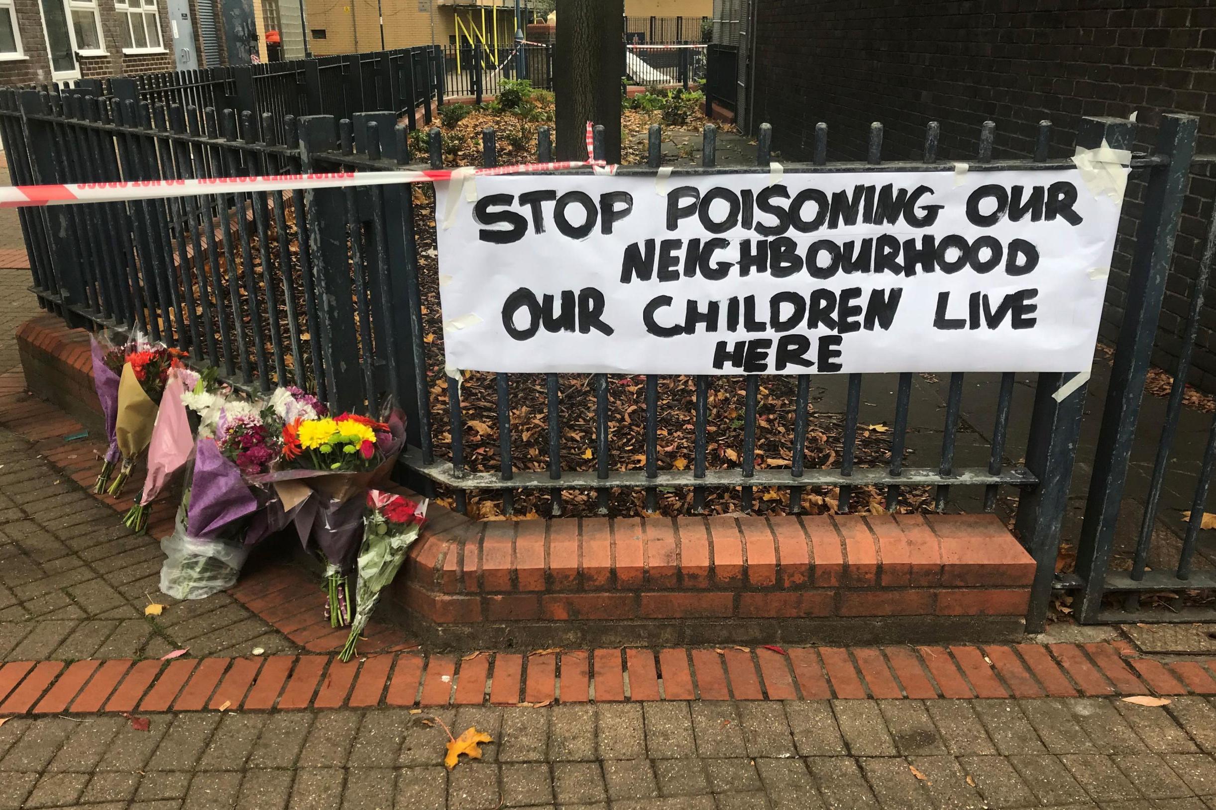 Floral tributes and a sign near where Ian Tomlin was killed