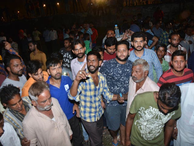 Crowd gathers at the site of a train accident in Amritsar, India