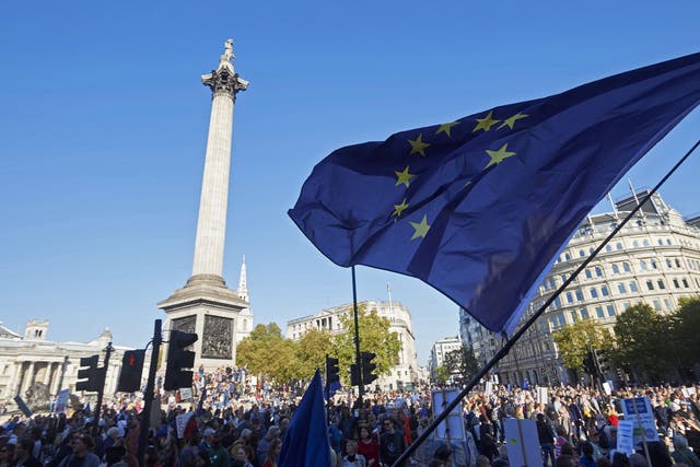 The EU flag flutters as the march passes Trafalgar Square