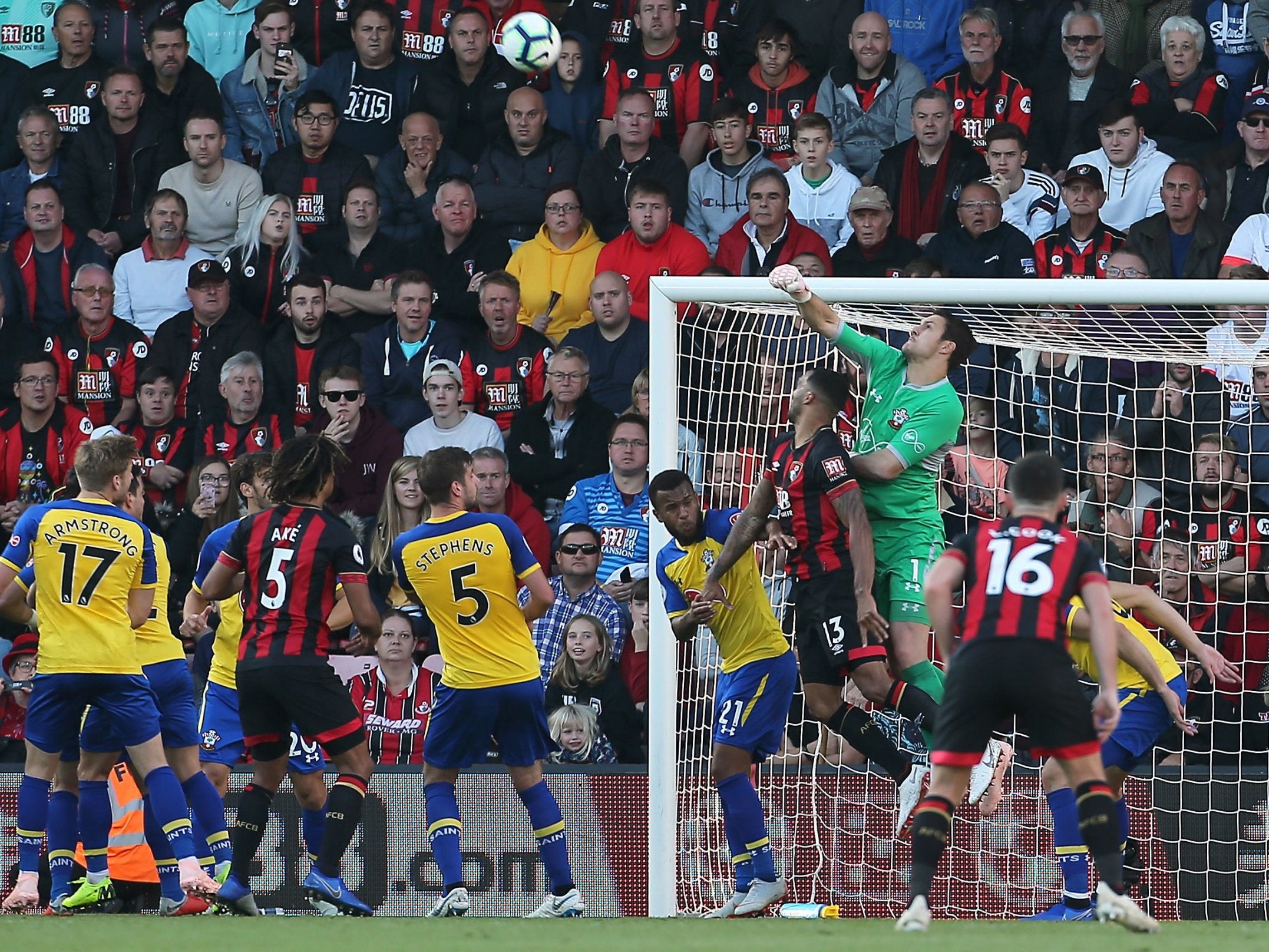 Southampton goalkeeper Alex McCarthy punches the ball away under pressure