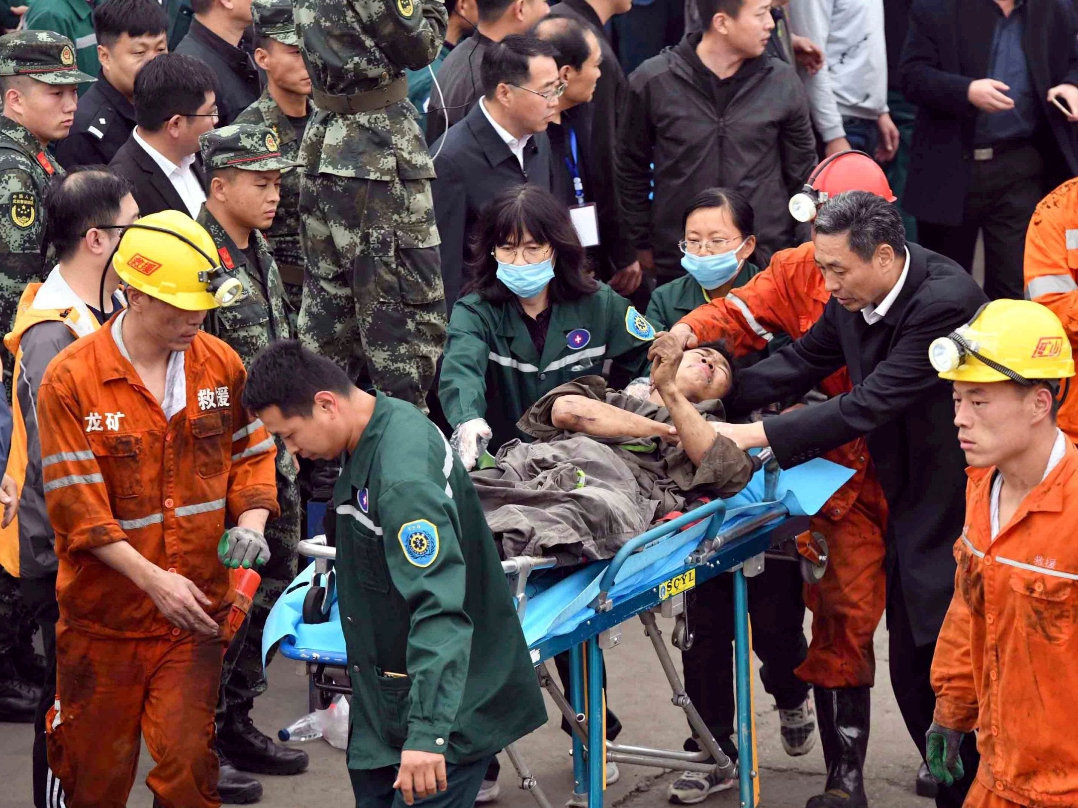 A miner is carried out after a rock burst destroyed part of a tunnel