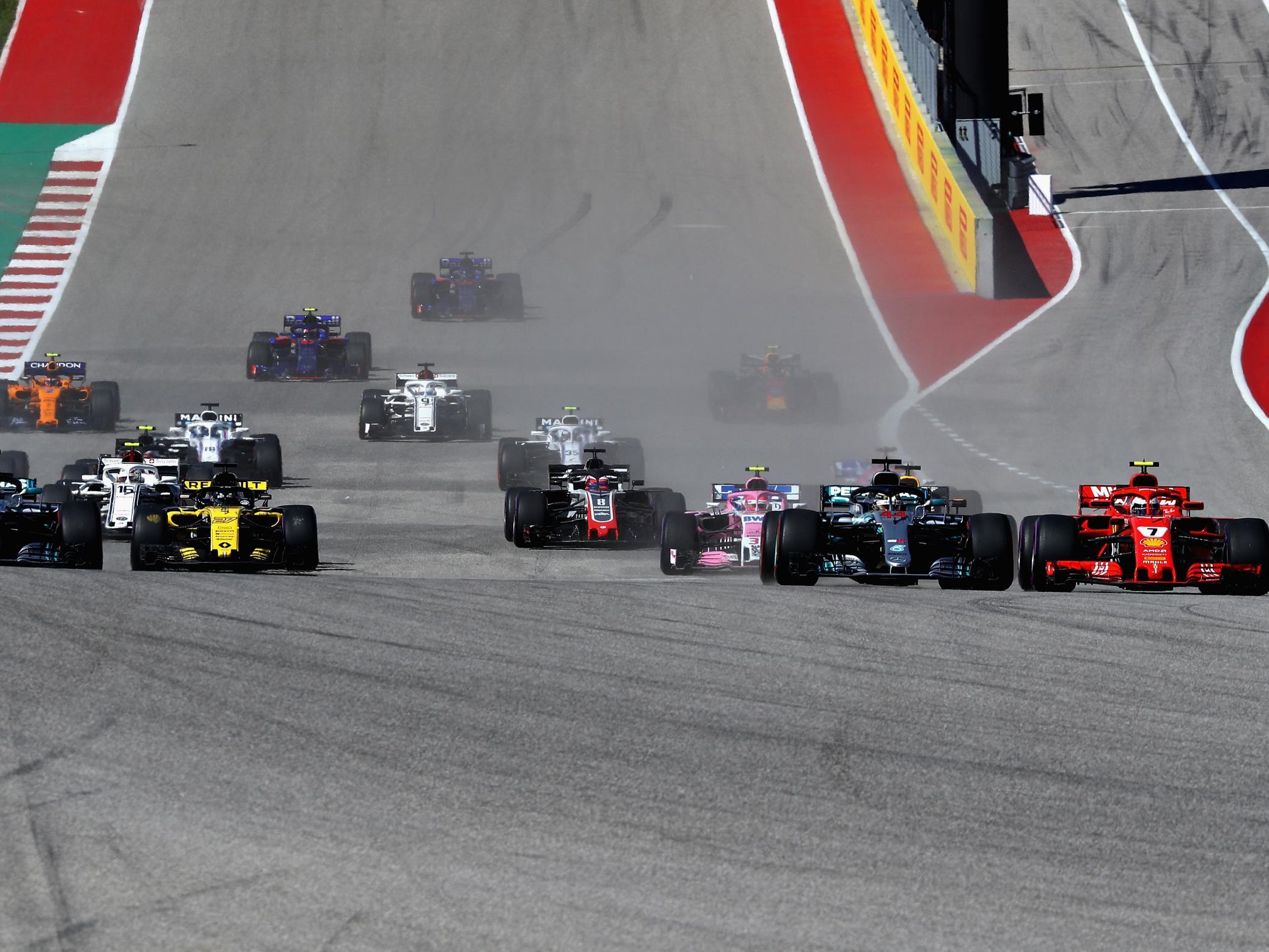 Kimi Raikkonen passes Lewis Hamilton at the start of the race