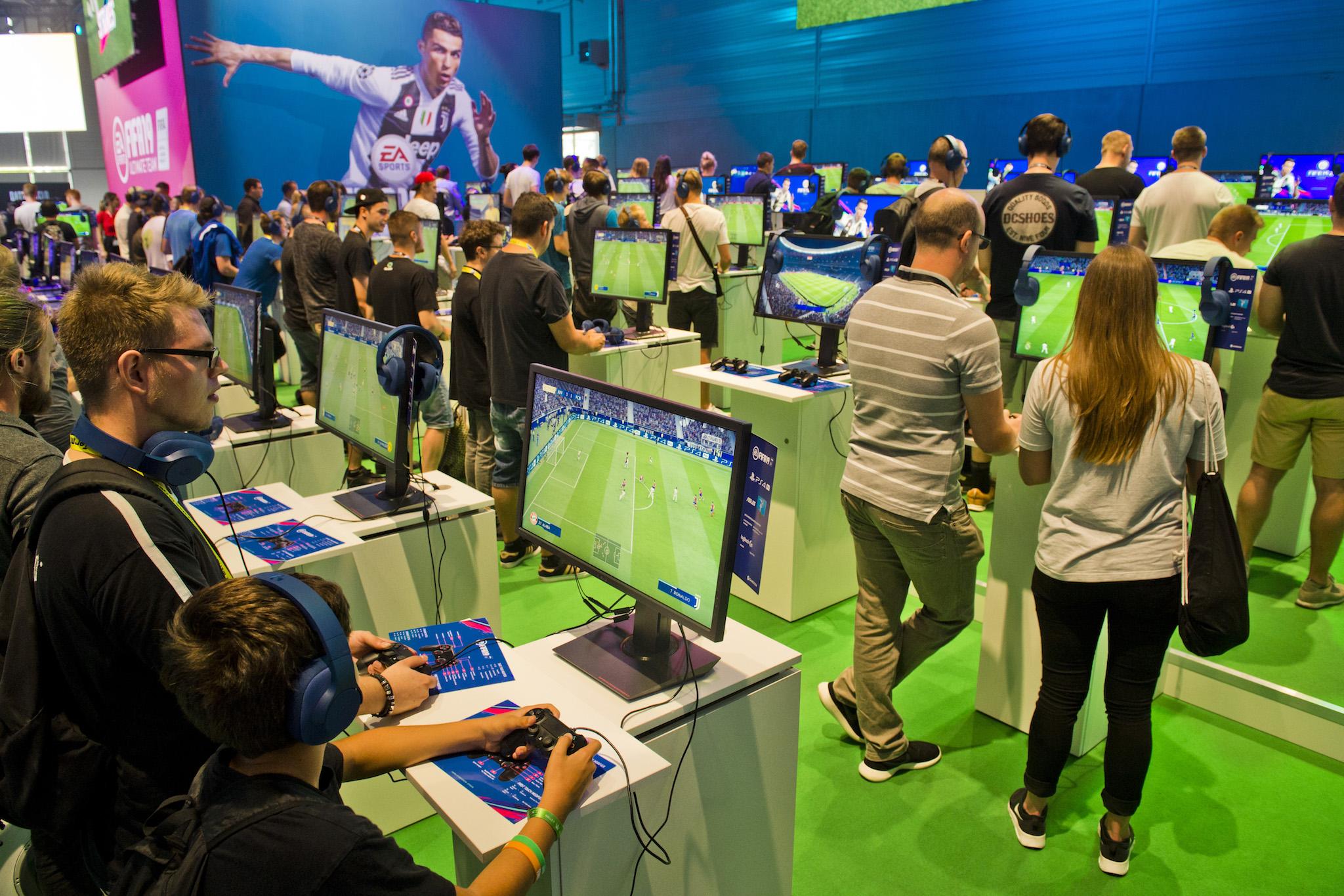 Visitors try Fifa 19 video game at 2018 gamescom fair press day on August 21, 2018 in Cologne, Germany