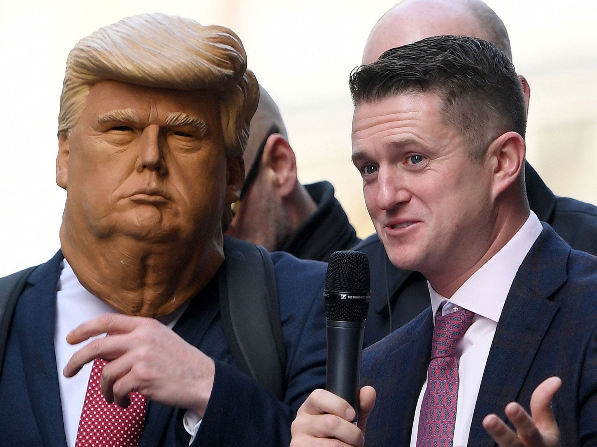 Tommy Robinson with a supporter dressed as Donald Trump addressing a crowd outside the Old Bailey at a rally organised by the Middle East Forum on 23 October (AFP/Getty Images)