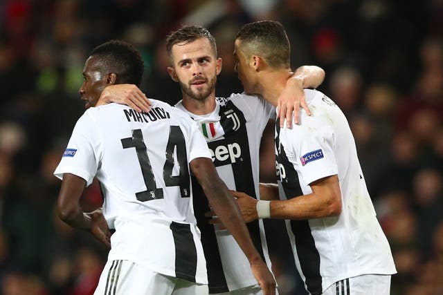 Miralem Pjanic celebrates Juventus's first goal with his teammates