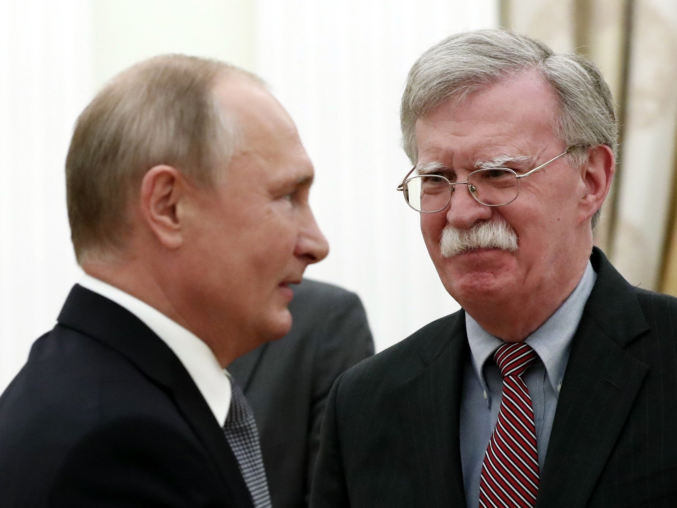 John Bolton, right, made the announcement after meeting President Putin at the Kremlin on Tuesday