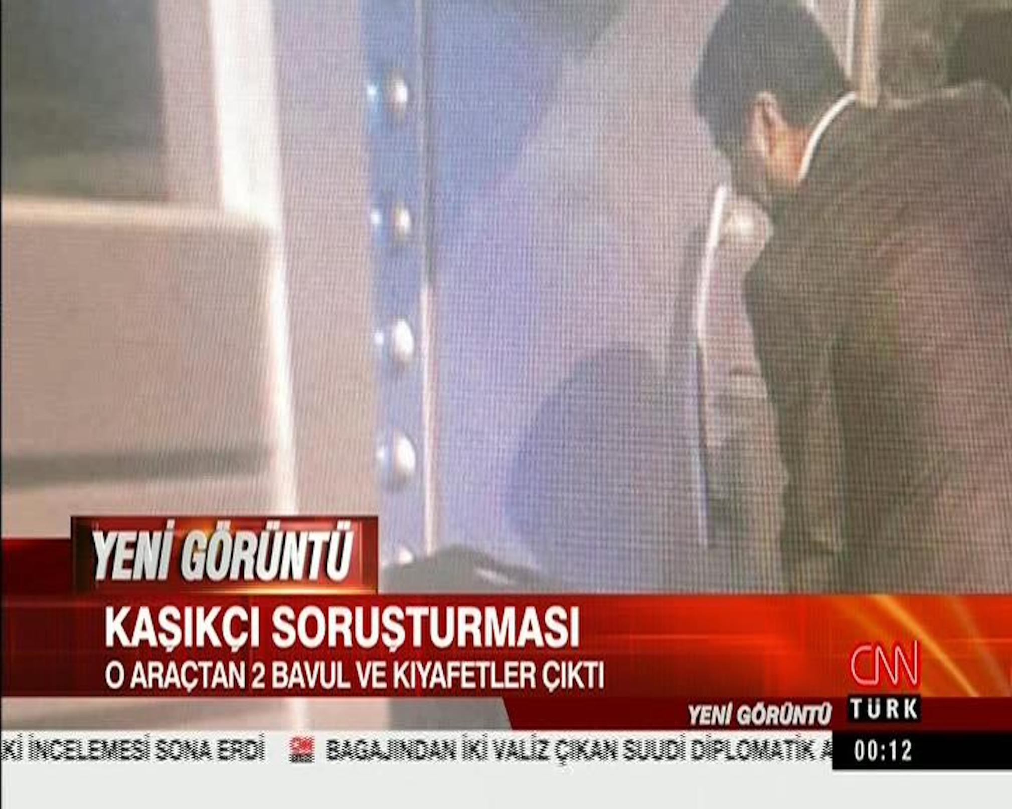 Still from security camera footage broadcast on CNN Turk shows what appears to be Saudi consular officials carrying a large case