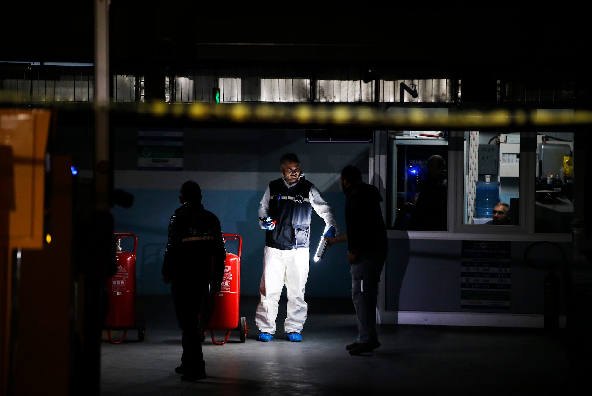 Turkish police crime scene investigators, looking for possible clues into the killing of Saudi journalist Jamal Khashoggi, work in an underground car park, where authorities Monday found a vehicle belonging to the Saudi consulate, in Istanbul, Tuesday, 23 October, 2018