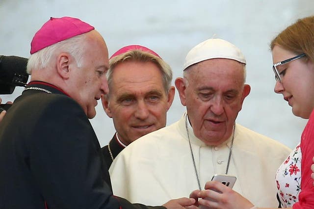 Pope Francis sends a message on a smartphone at the Vatican, July 31, 2018