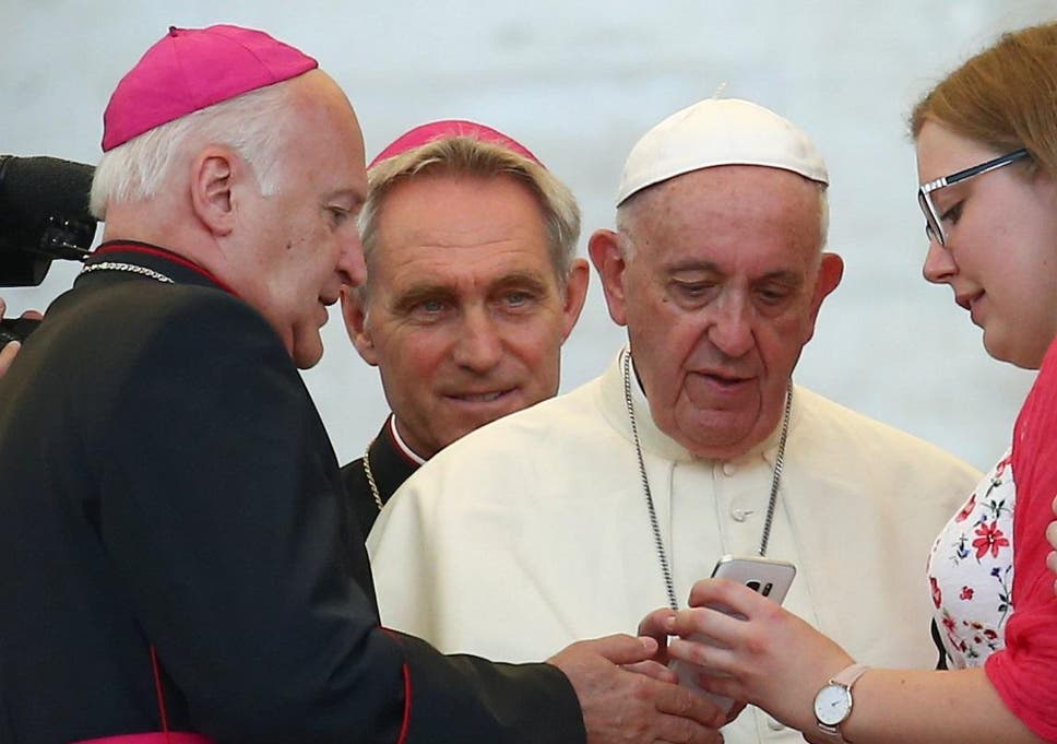 Pope Francis sends a message on a smartphone at the Vatican, July 31, 2018