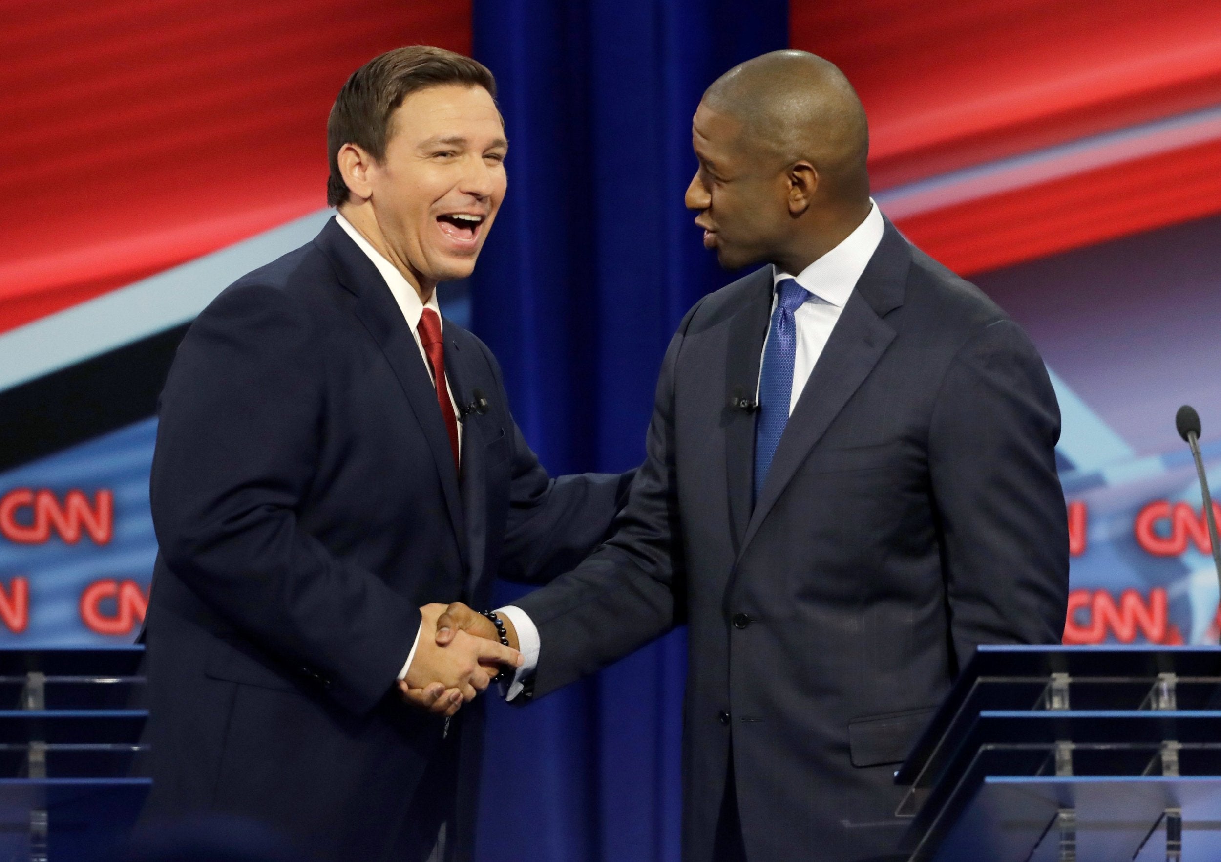 DeSantis and Gillum shake hands during their final debate in Davie, Florida (Reuters)