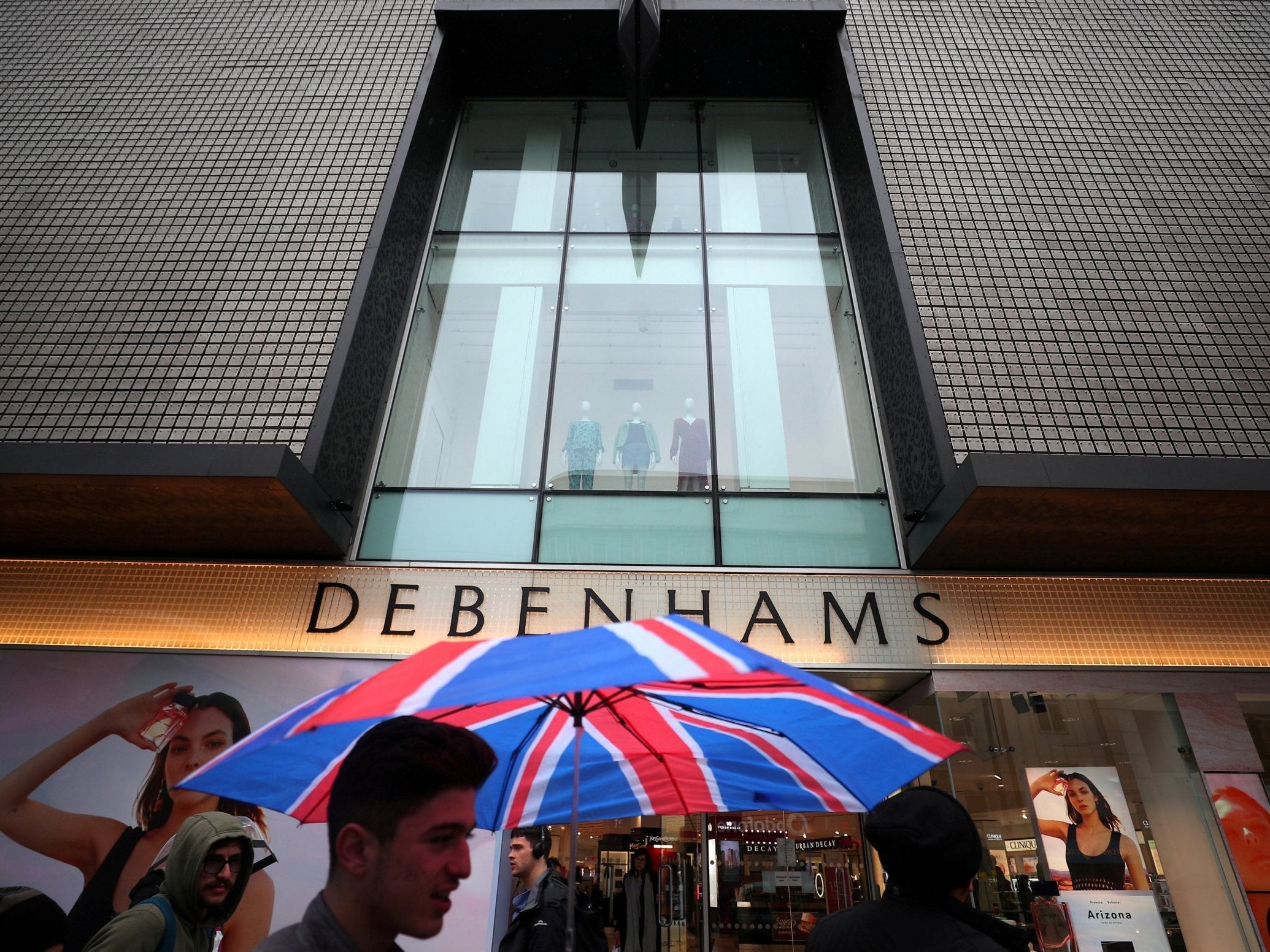 Shoppers walk past Debenhams in Oxford Street in central London