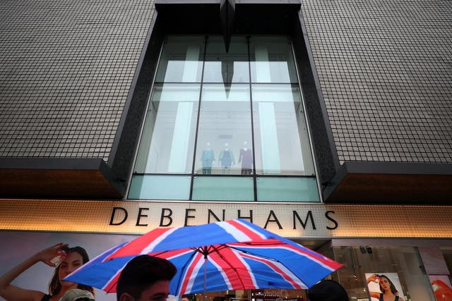 Shoppers walk past Debenhams in Oxford Street in central London
