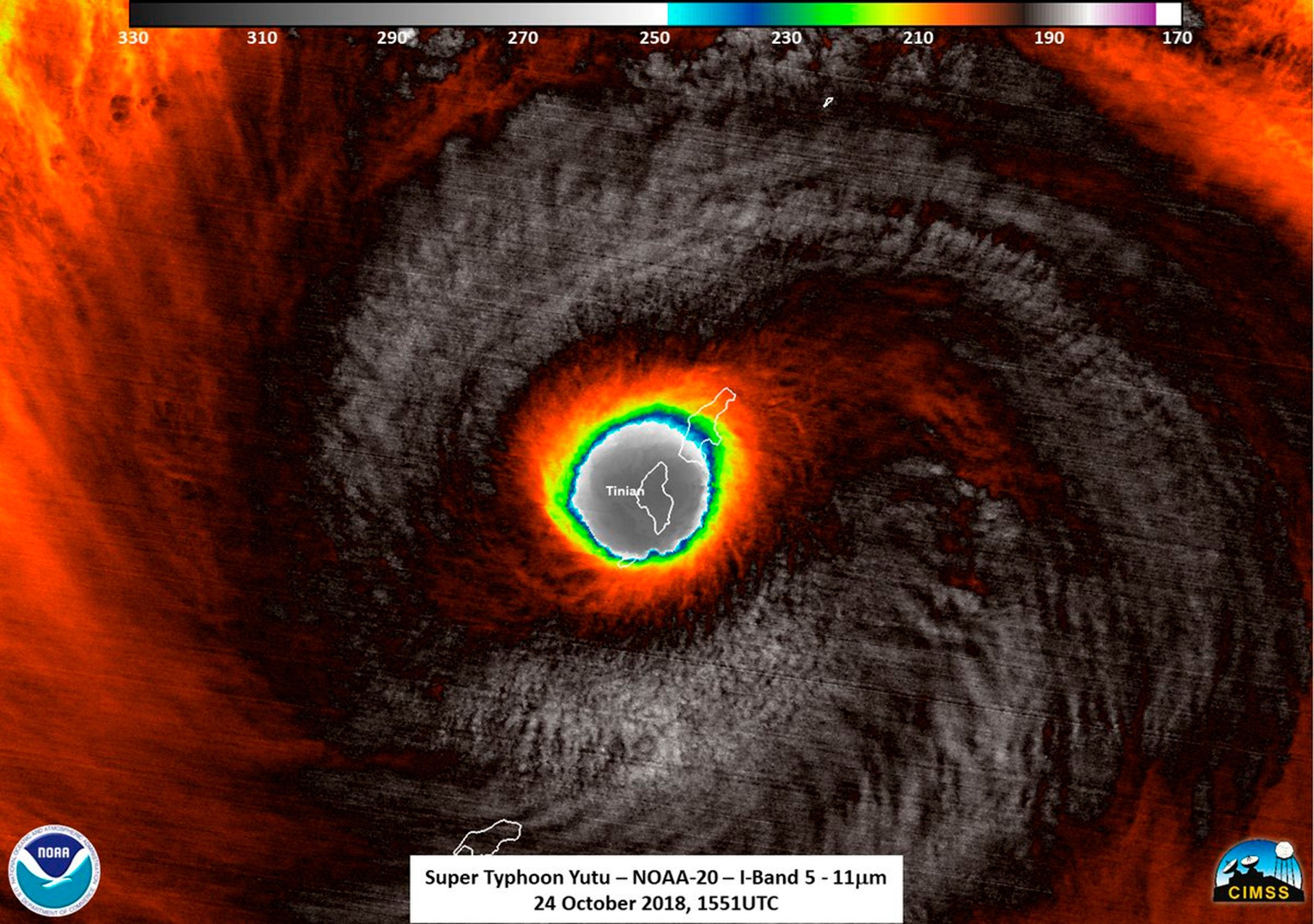 This false-color satellite image provided by the National Oceanic and Atmospheric Administration (NOAA) shows the moment the eye of Super Typhoon Yutu passed over Tinian