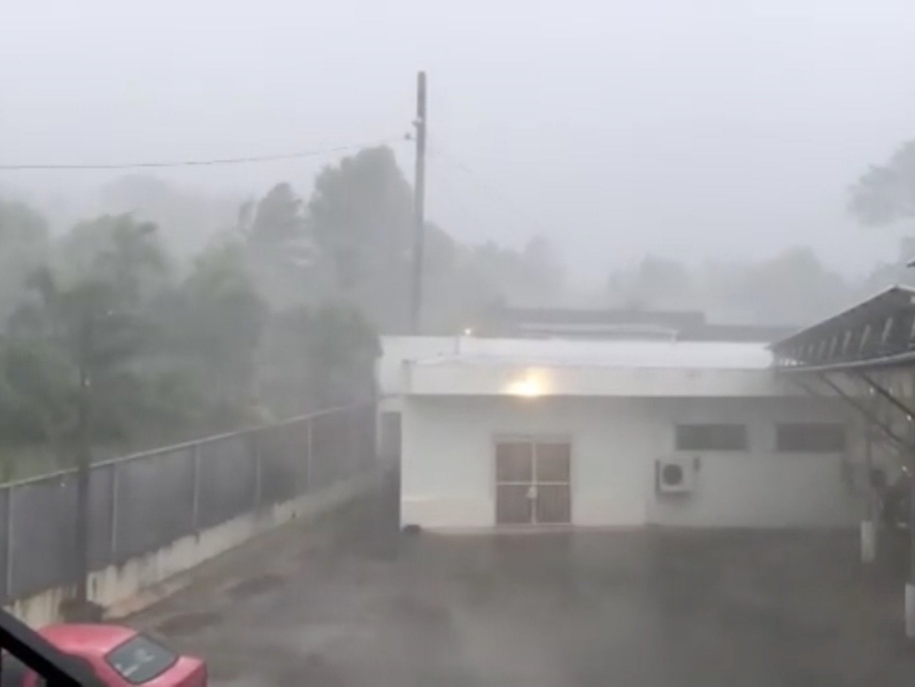 A storm batters buildings as Super Typhoon Yutu descends upon Saipan