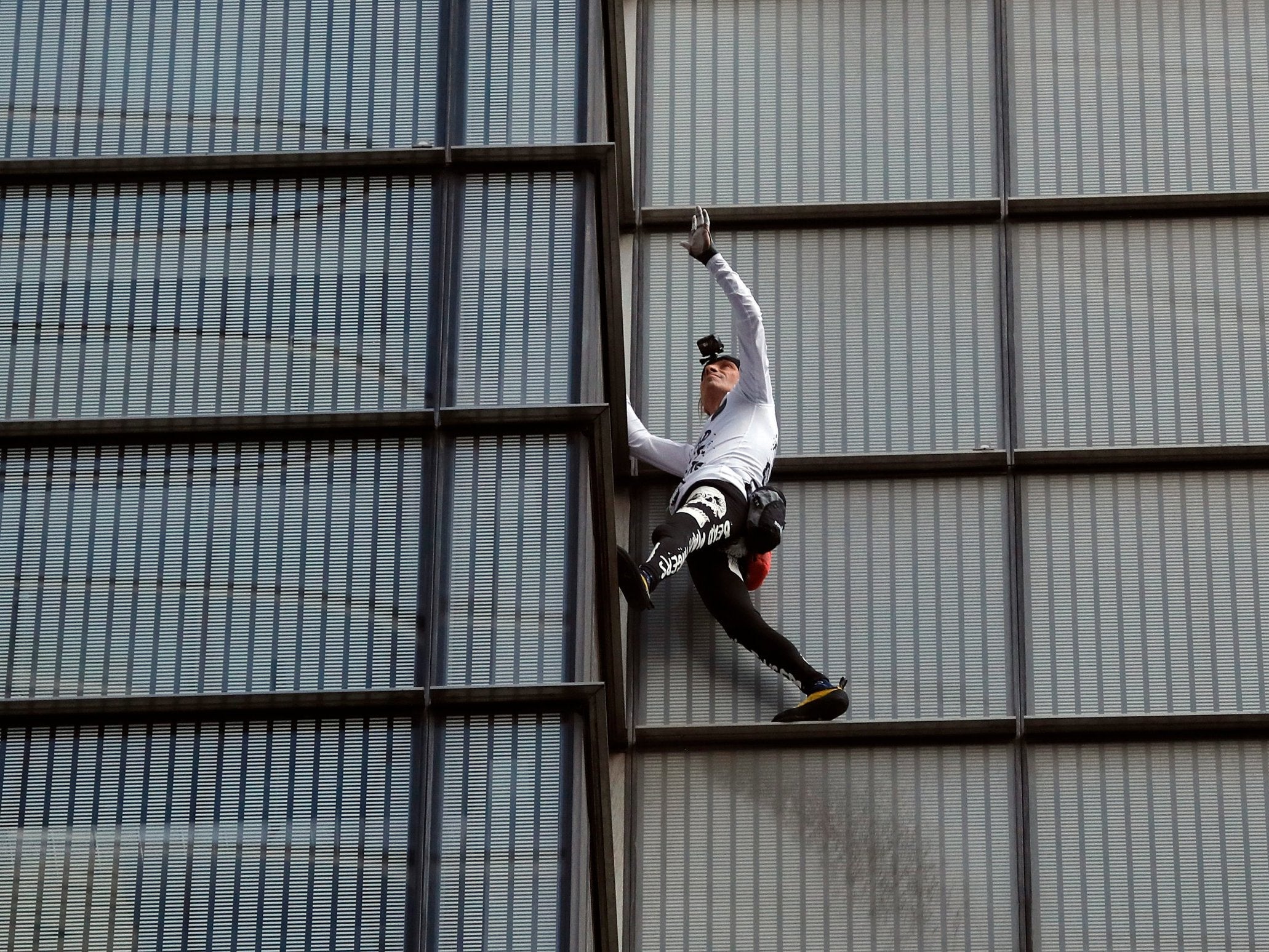 On the way up. Alain Robert reached the top of the 202-metre skyscraper in 40 minutes