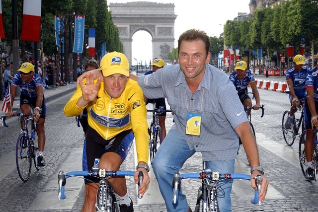 Lance Armstrong and Johan Bruyneel celebrate after the 2002 Tour