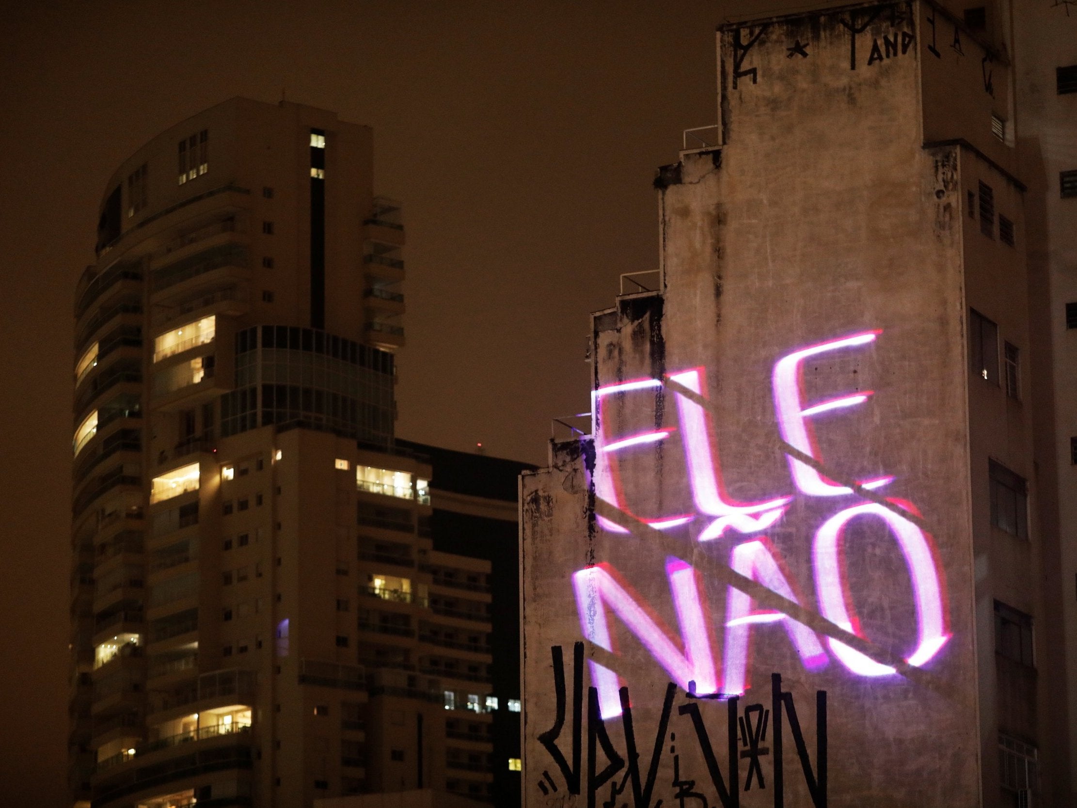 The phrase "#NotHim" projected on Sao Paulo building in reference to candidate Jair Bolsonaro