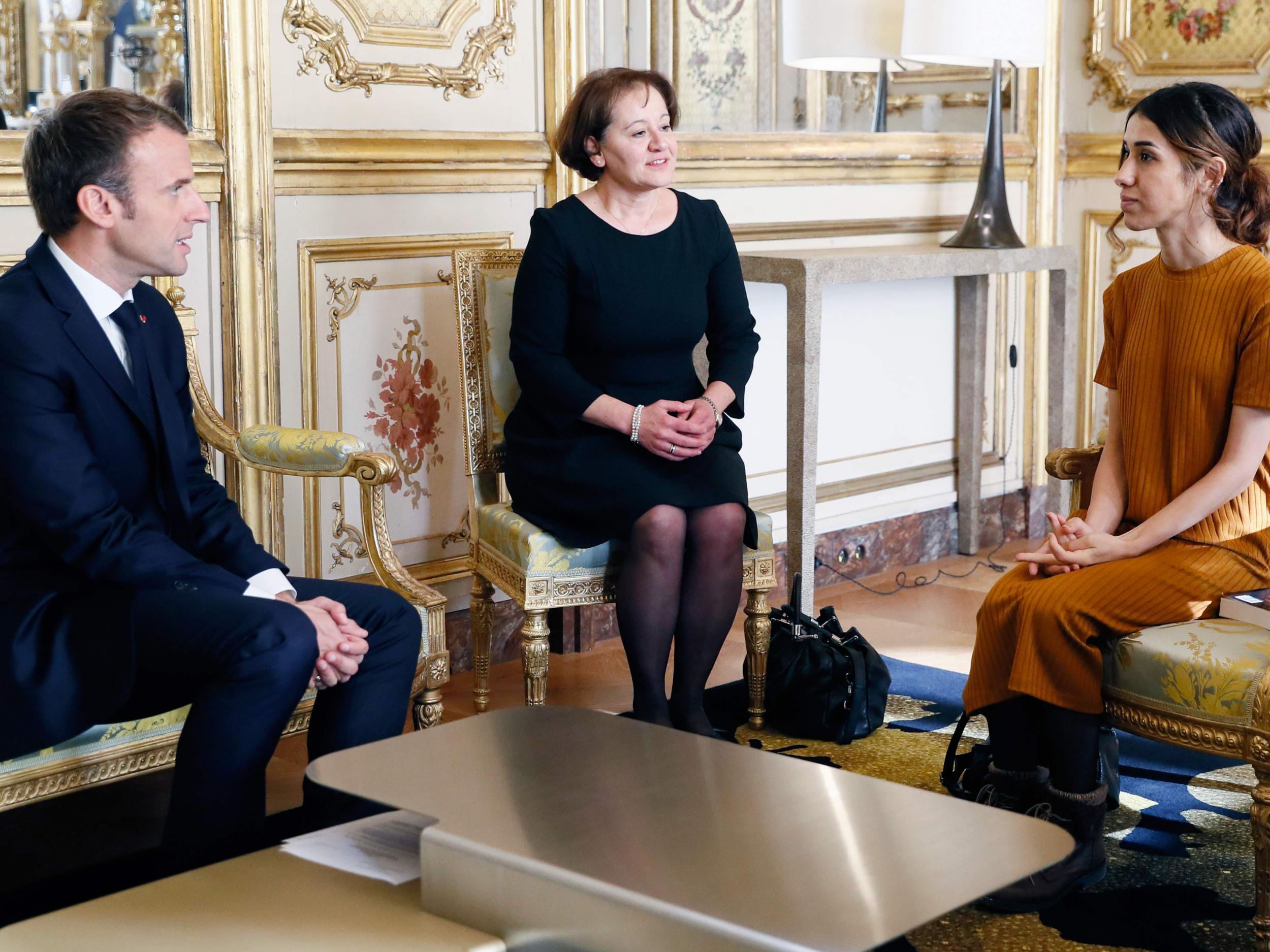 French President Emmanuel Macron speaks with human rights activist Nadia Murad during a meeting at the Elysee palace in Paris