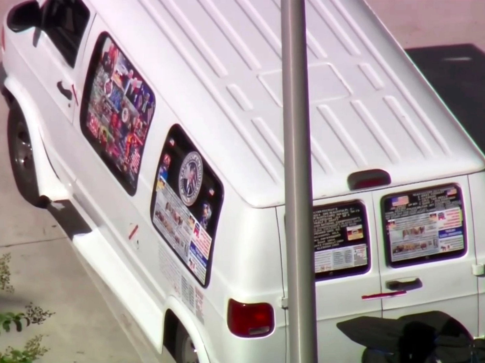 The van appears to have pro-Trump and pro-Republican stickers and decals on it
