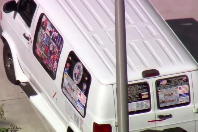 The van appears to have pro-Trump and pro-Republican stickers and decals on it
