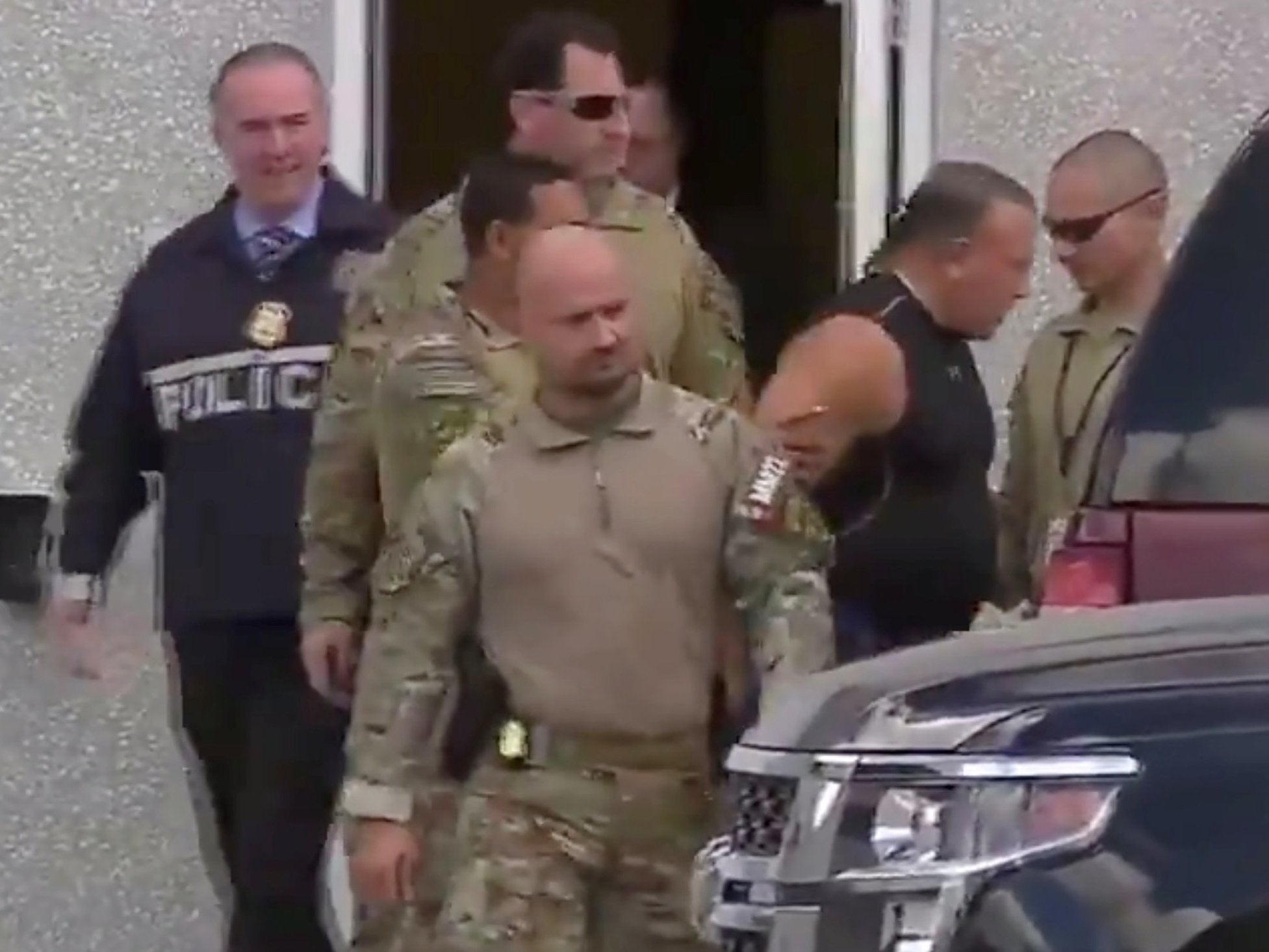Cesar Sayoc is escorted from an FBI facility in Miramar, Florida.