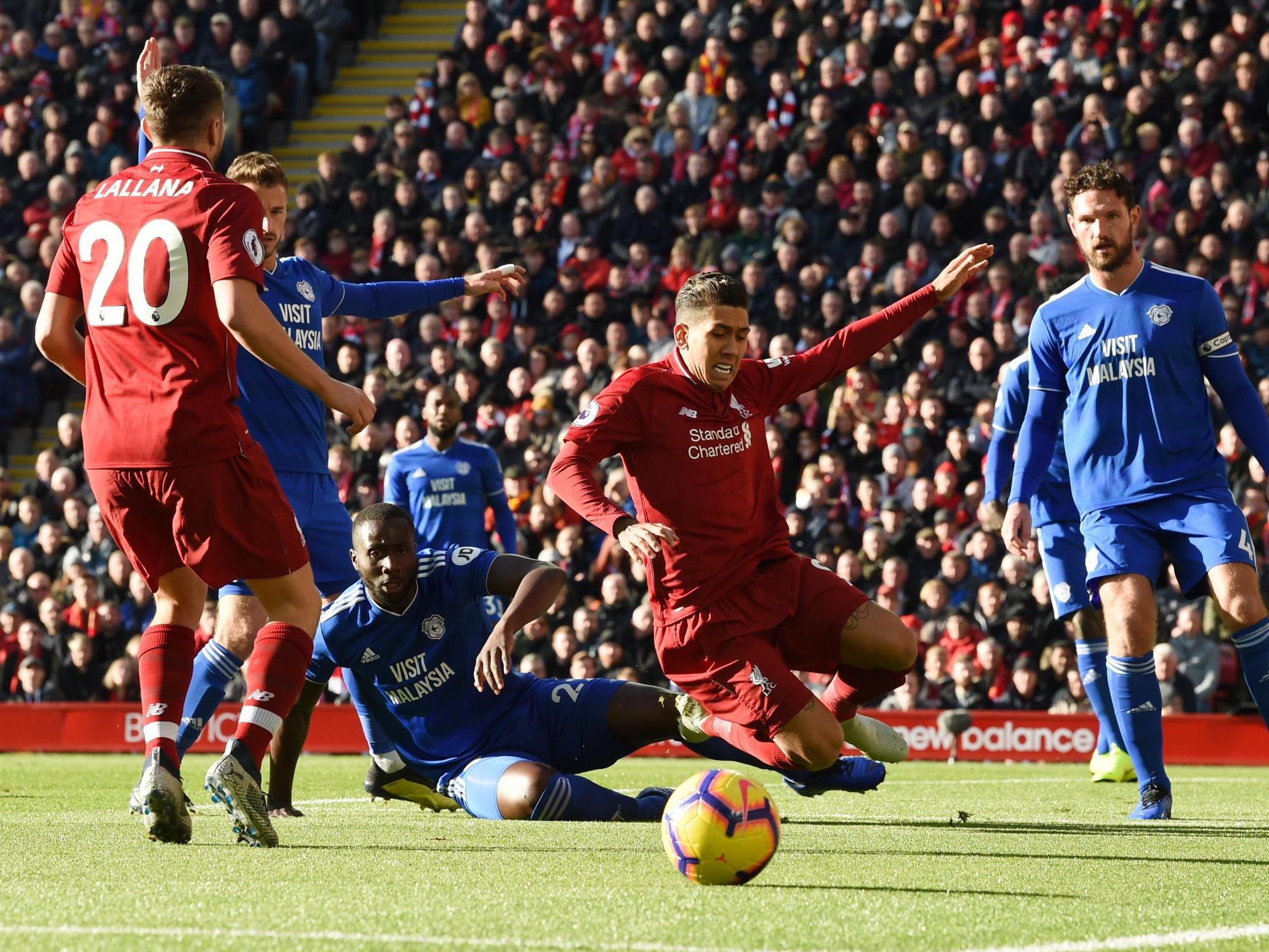 Roberto Firmino goes to ground following a challenge from Sol Bamba