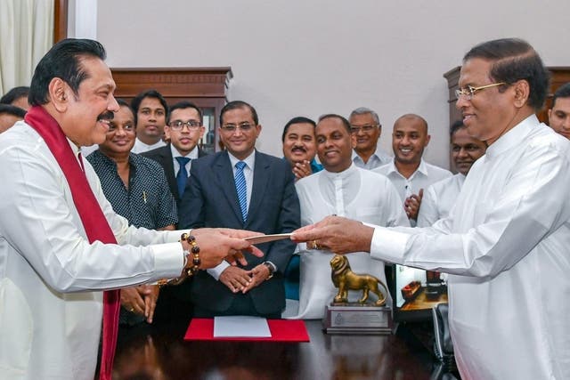 New prime minister Mahinda Rajapaksa (left) sworn in by President Maithripala Sirisena