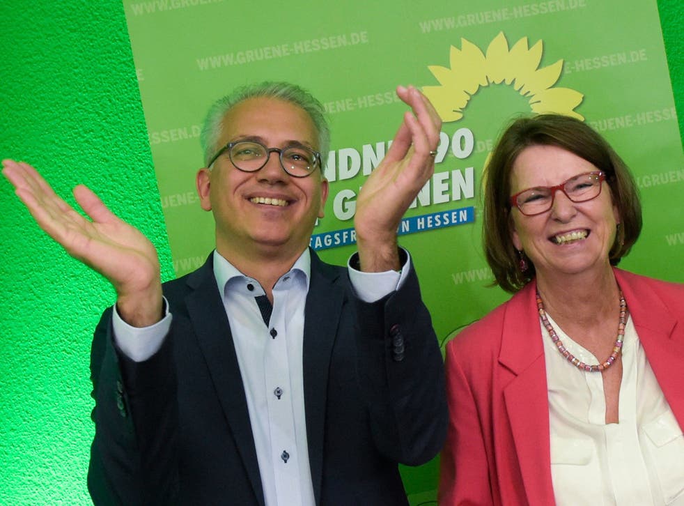 Green Party top candidates Tarek Al-Wazir, left, and Priska Hinz, right, arrives at a party's election party, after first results of the Hesse state election announced.