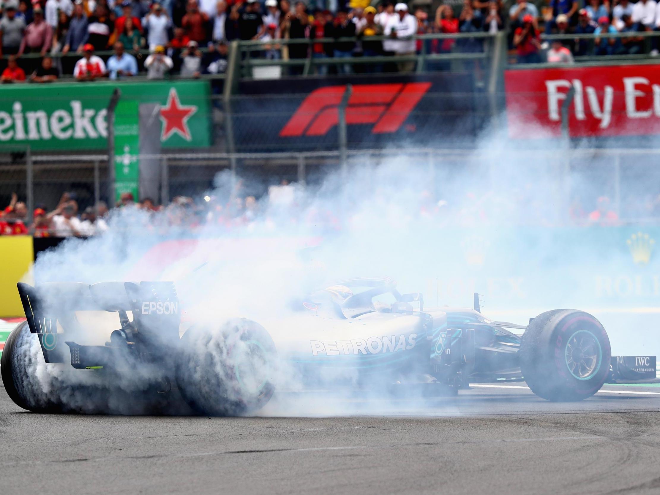 Lewis Hamilton celebrates his victory with a series of donuts on the track