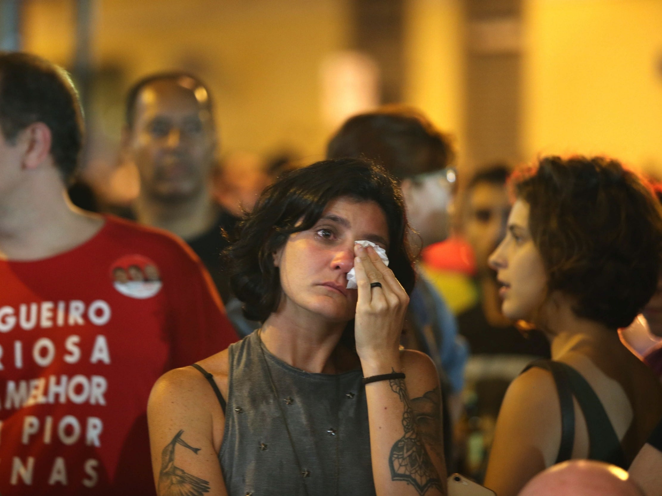 Supporters of Socialist candidate Fernando Haddad react after he was defeated by far-right candidate Jair Bolsonaro