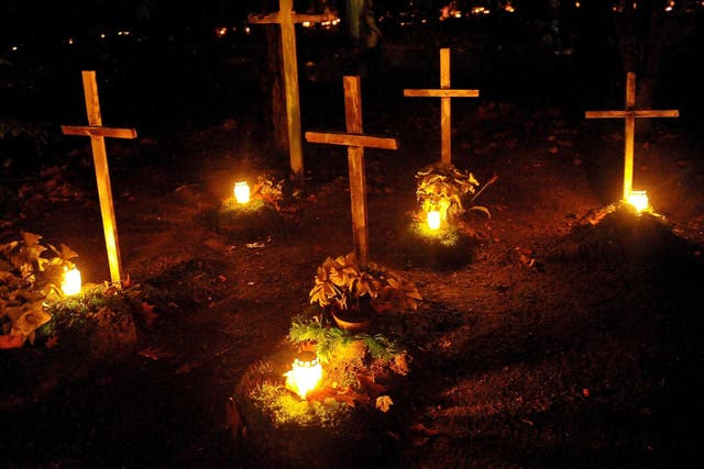Candles burn on All Saints' Day at the Central Cemetery in Szczecin, Poland